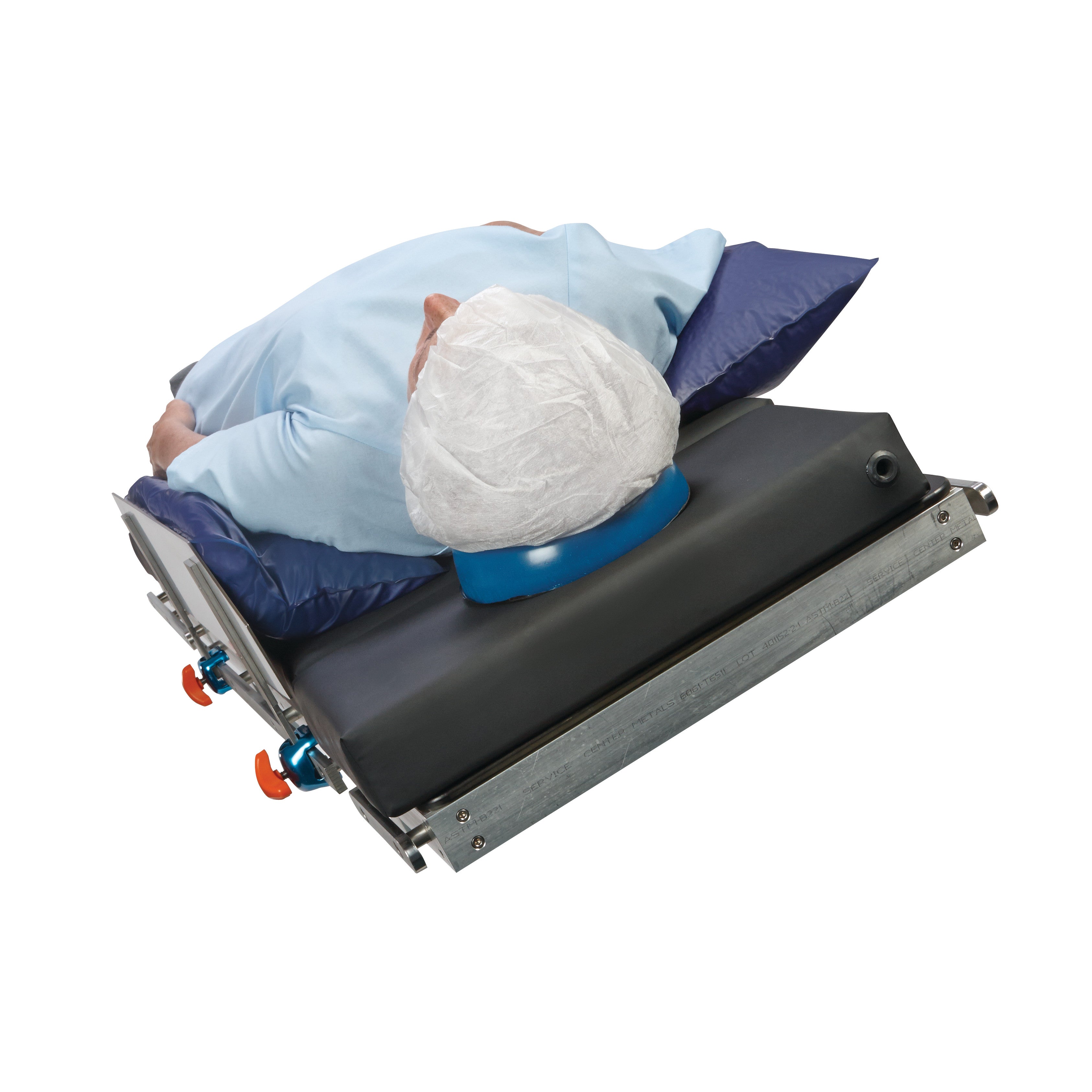 A patient lies on their side on an AliMed Lateral Fence, supported by cushions, with their head in a protective cover.