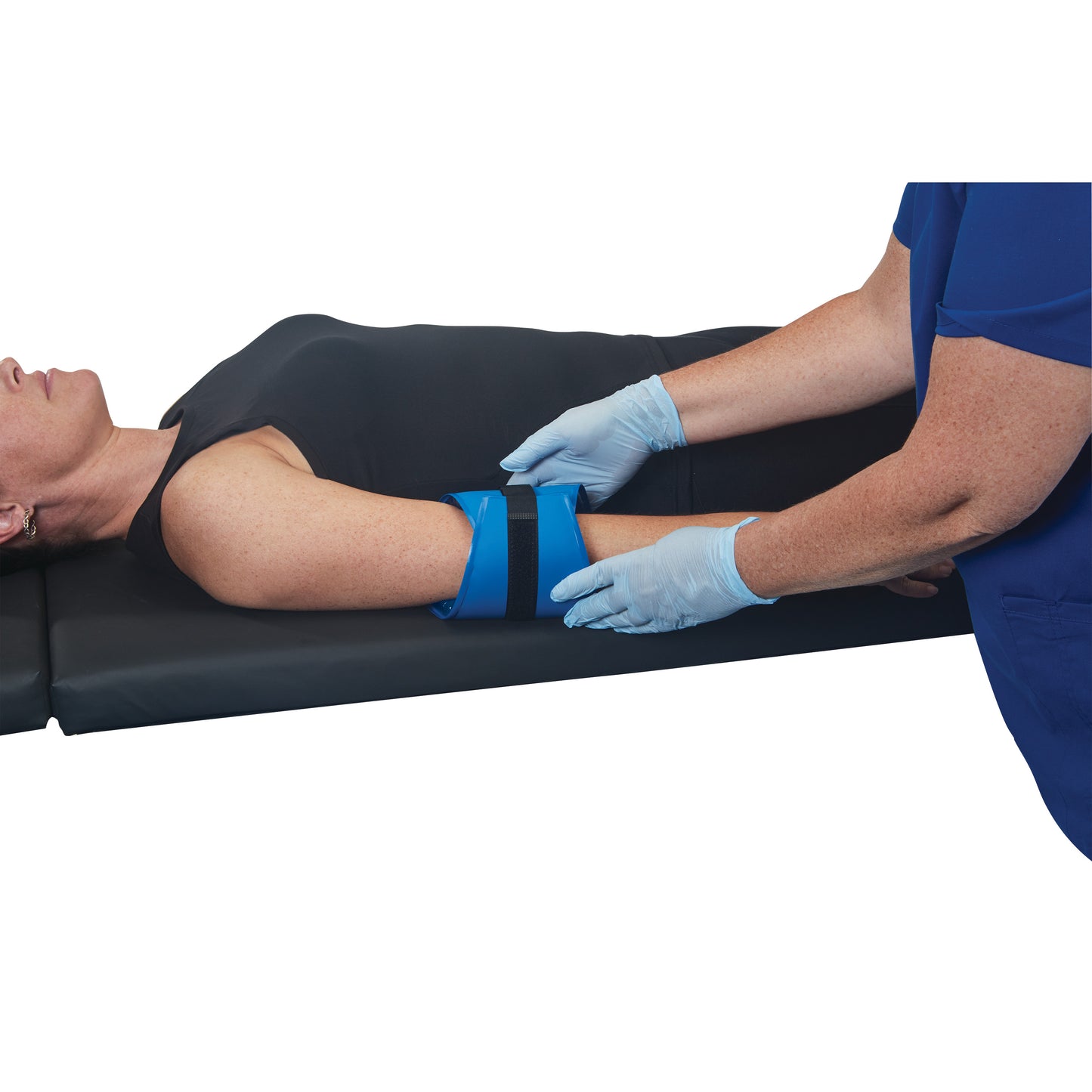 A person lying on their back has the AliMed AliBlue Gel Ulnar Nerve Protector placed on their arm, secured by a strap.
