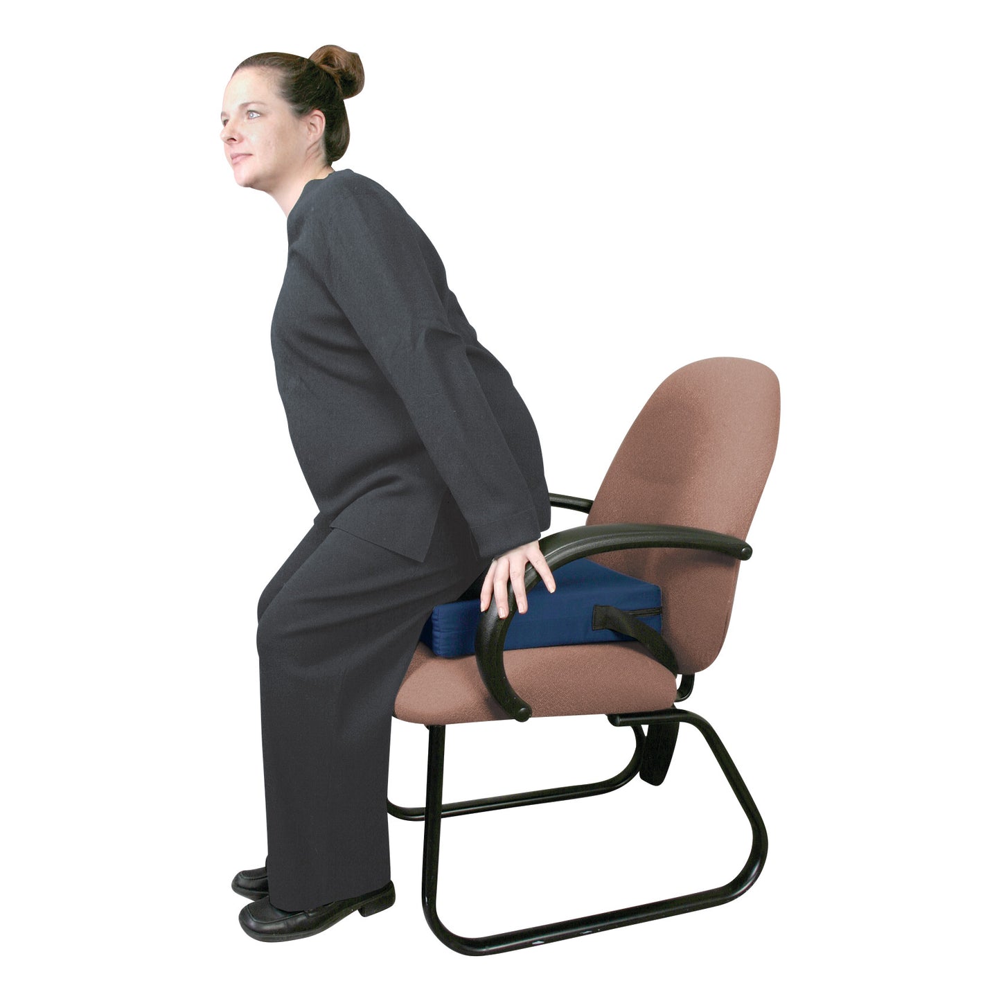 A person demonstrates the AliMed Portable Easy Up Sit-to-Stand Cushion on a chair, aiding in standing assistance.