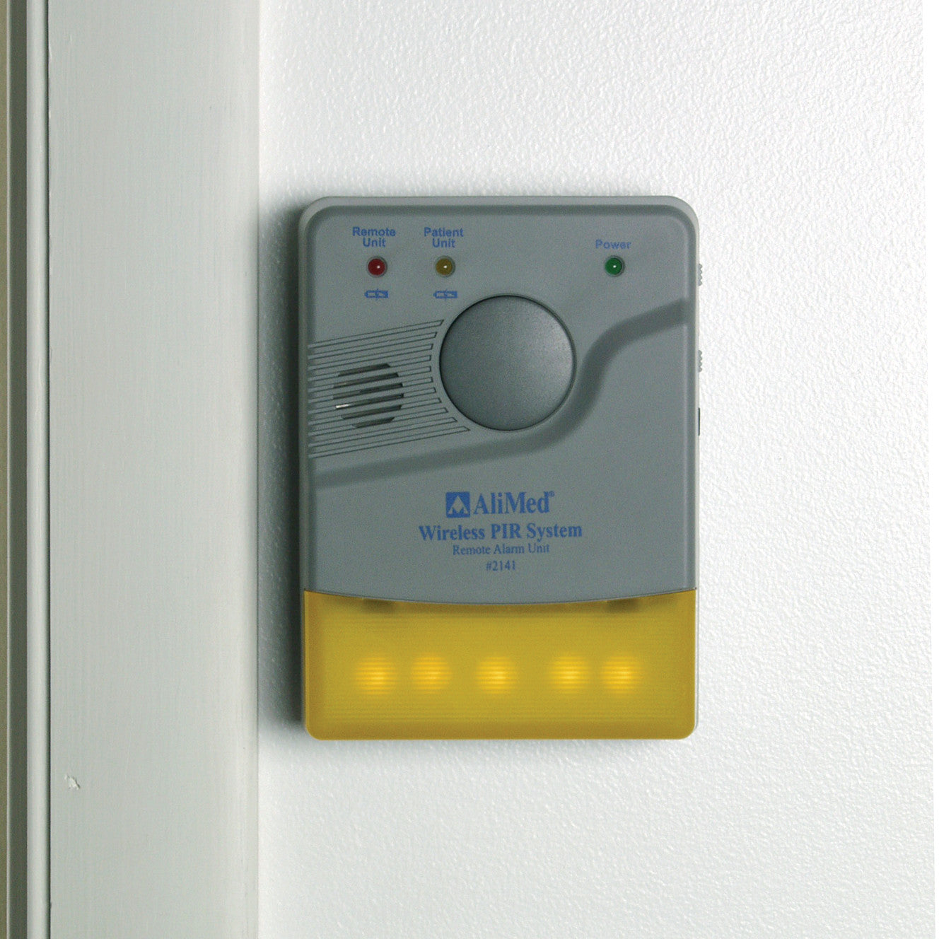 An AliMed Remote Receiver Alarm Unit, with indicator lights and a speaker, is mounted on a white wall.