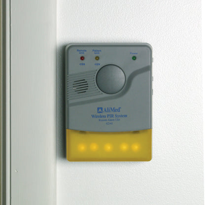 An AliMed Remote Receiver Alarm Unit, with indicator lights and a speaker, is mounted on a white wall.