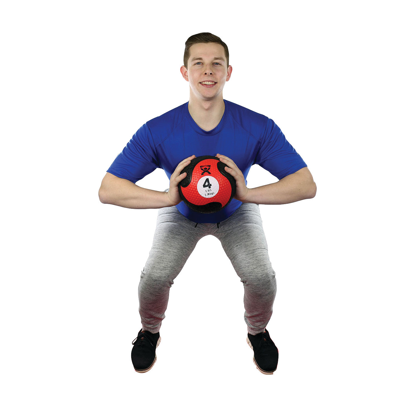A man squats while holding a CanDo Rubber Medicine Ball, weighing 4 pounds, against a white background.