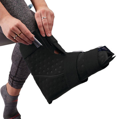 Person adjusting a Bootie for Pain Management Technologies Hot/Cold Therapy Aqua Relief System on their foot.
