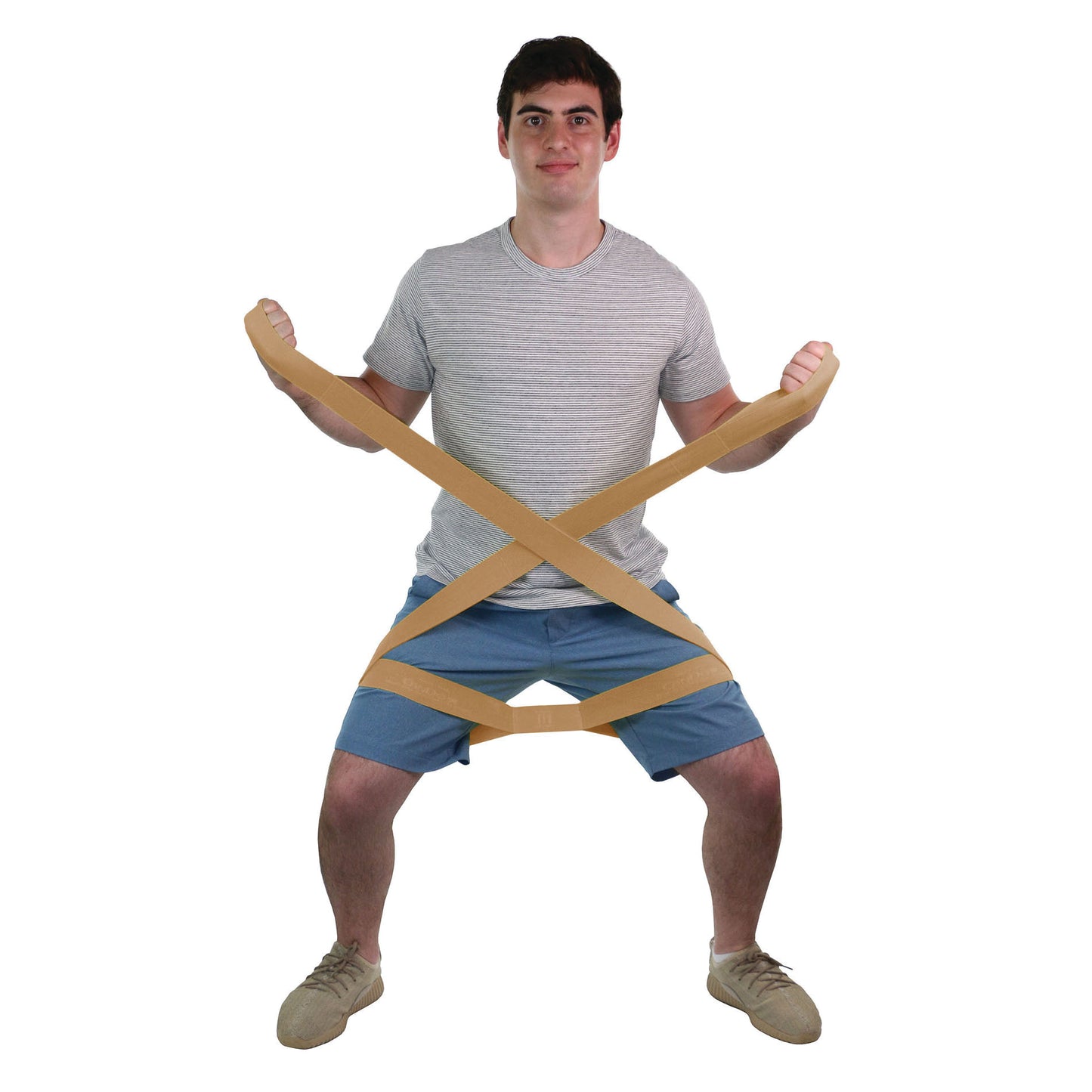 A person uses the CanDo Multi-Grip Exerciser, a tan resistance band, for squatting exercises in a white background.