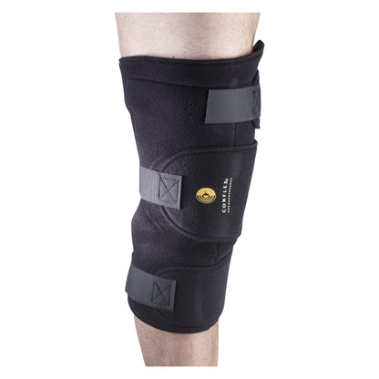 A person's knee is wrapped with a Cryotherm Cold and Hot Compression Wrap, featuring adjustable straps for secure fitting.