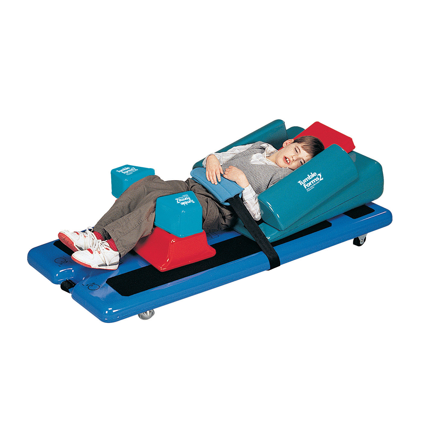 A child is secured in a Tumble Forms2 Universal Grasshopper Positioning System, lying on a blue platform with red and blue cushions.