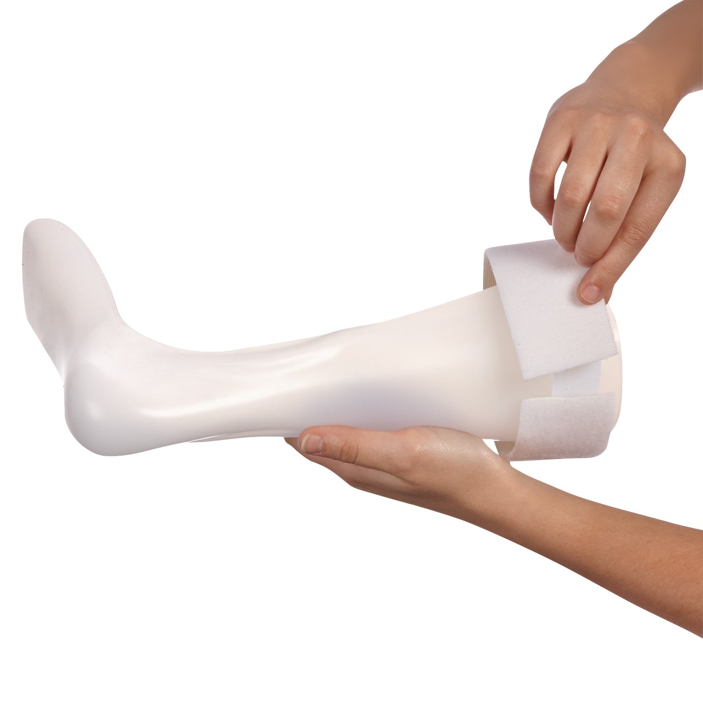 Hands hold a white prosthetic leg with an AliMed Beta Soft Strap Loop being adjusted around it.