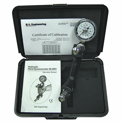 A B&L Engineering Hand Dynamometer with a gauge is in an open case with  a Certificate of Calibration and an operating manual.