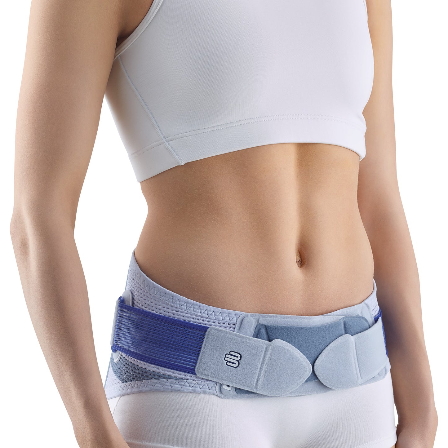 A person wearing a Bauerfeind SacroLoc support belt around their lower waist, over light clothing, highlighting the adjustable straps.