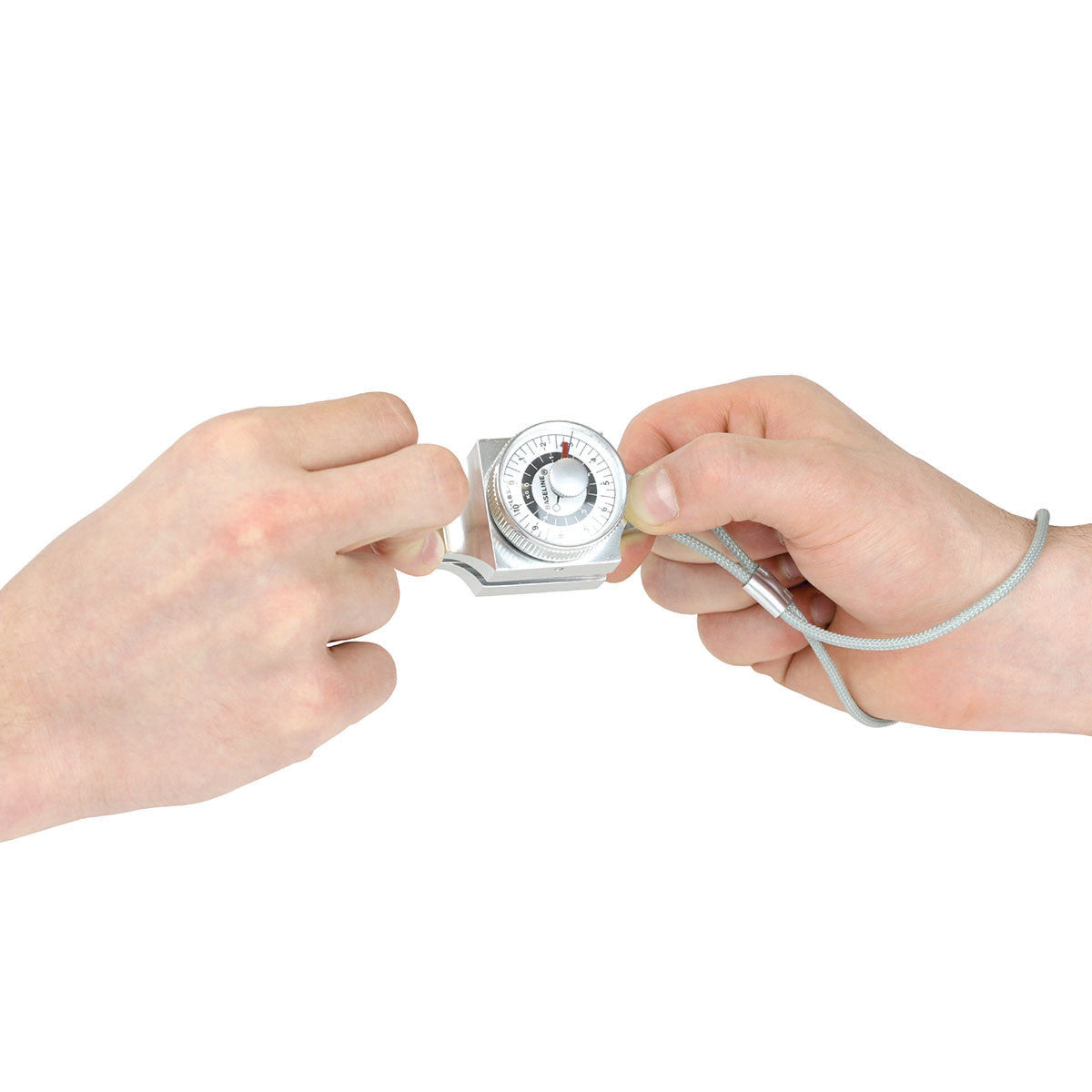 Two hands using a Baseline Pinch Gauge. The device features a circular dial for measuring grip strength, linked by a wrist strap.
