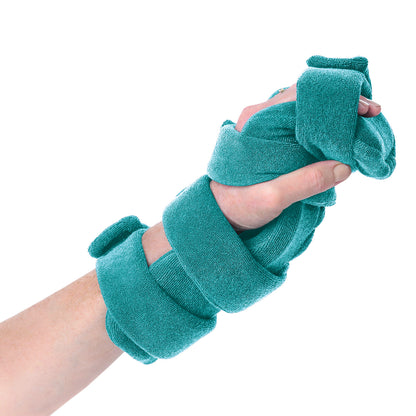 A hand is wrapped in the Comfy Splints Pediatric 4-Strap Hand/Thumb Orthosis with teal fabric straps for support and stabilization.