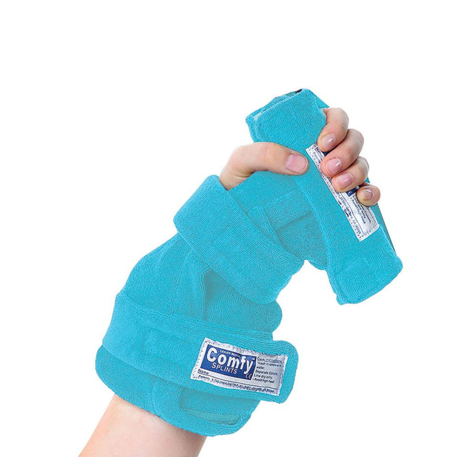 A child's hand is wearing a Comfy Splints Pediatric Deviation Finger Extender Hand Orthosis, secured with adjustable straps.