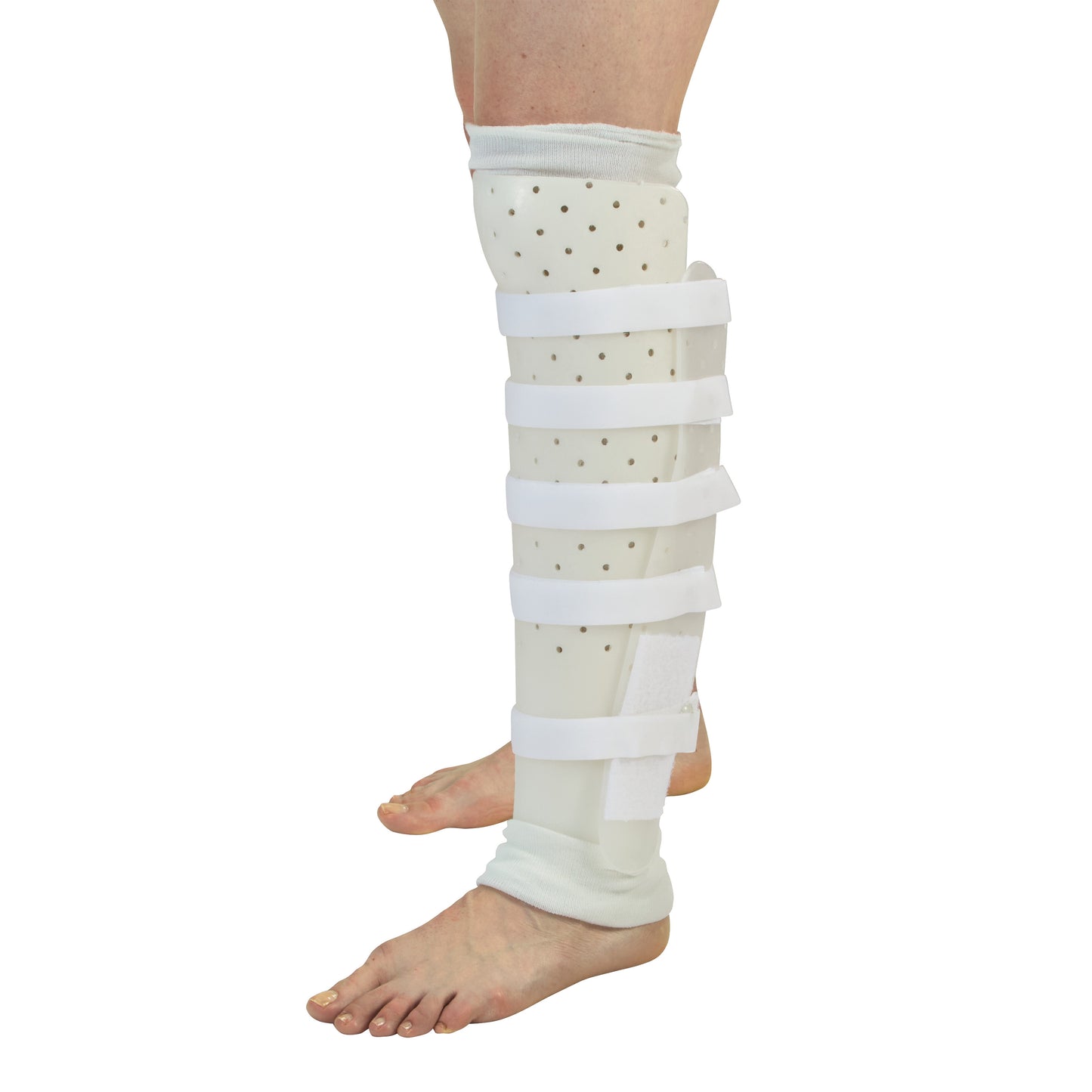 A person's leg wearing a Miami Tibial Fracture PTB Brace, which is white with adjustable straps and covers the shin to the foot.