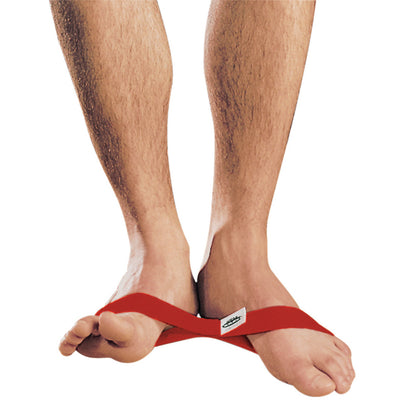 A person's feet wearing the AnkleTough Rehab System red resistance band, wrapped around the arches for rehabilitation exercises.