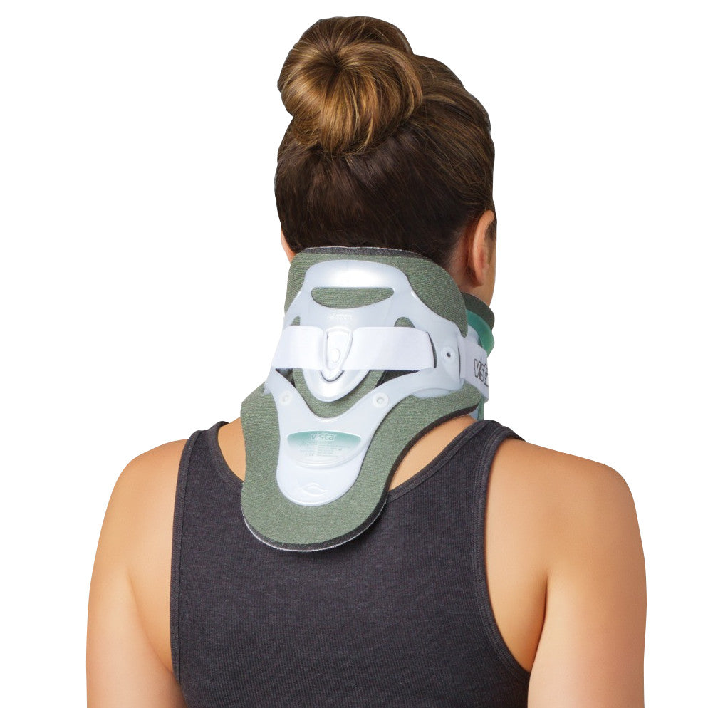 A person wearing an Aspen Vista TX Cervical Collar Set, showing the back view. The collar is white and green with straps.