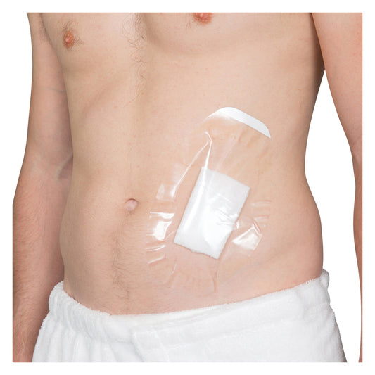 A person with a Brownmed SEAL-TIGHT Shield covering a wound on their abdomen, secured with a transparent adhesive.
