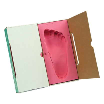 FoamArt Foot Impression Foam with a pink foot imprint inside an open cardboard box, showing detailed shape and contours of the foot.