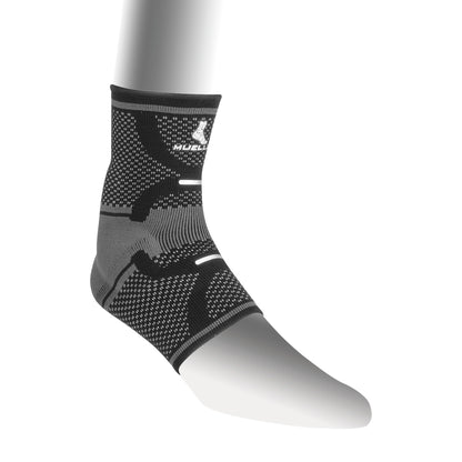 Mueller Omniforce Ankle Support in black and gray shown on a mannequin leg, featuring a textured pattern and elastic bands.