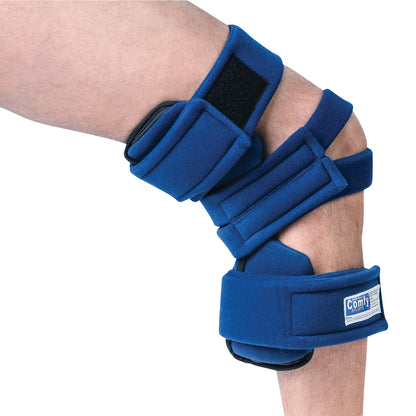 A person wears a Comfy Splints Adult Goniometer Knee Orthosis with blue padding and adjustable straps on their bent knee.