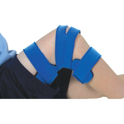 A child's knee is supported by the Comfy Splints Pediatric Goniometer Knee Orthosis with blue adjustable straps.