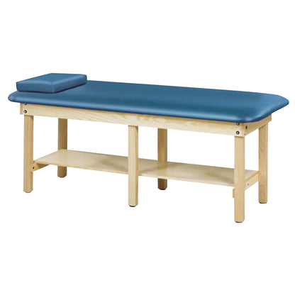 Clinton Bariatric Treatment Table with a blue cushioned top, wooden frame, and a lower shelf for storage, designed for medical use.