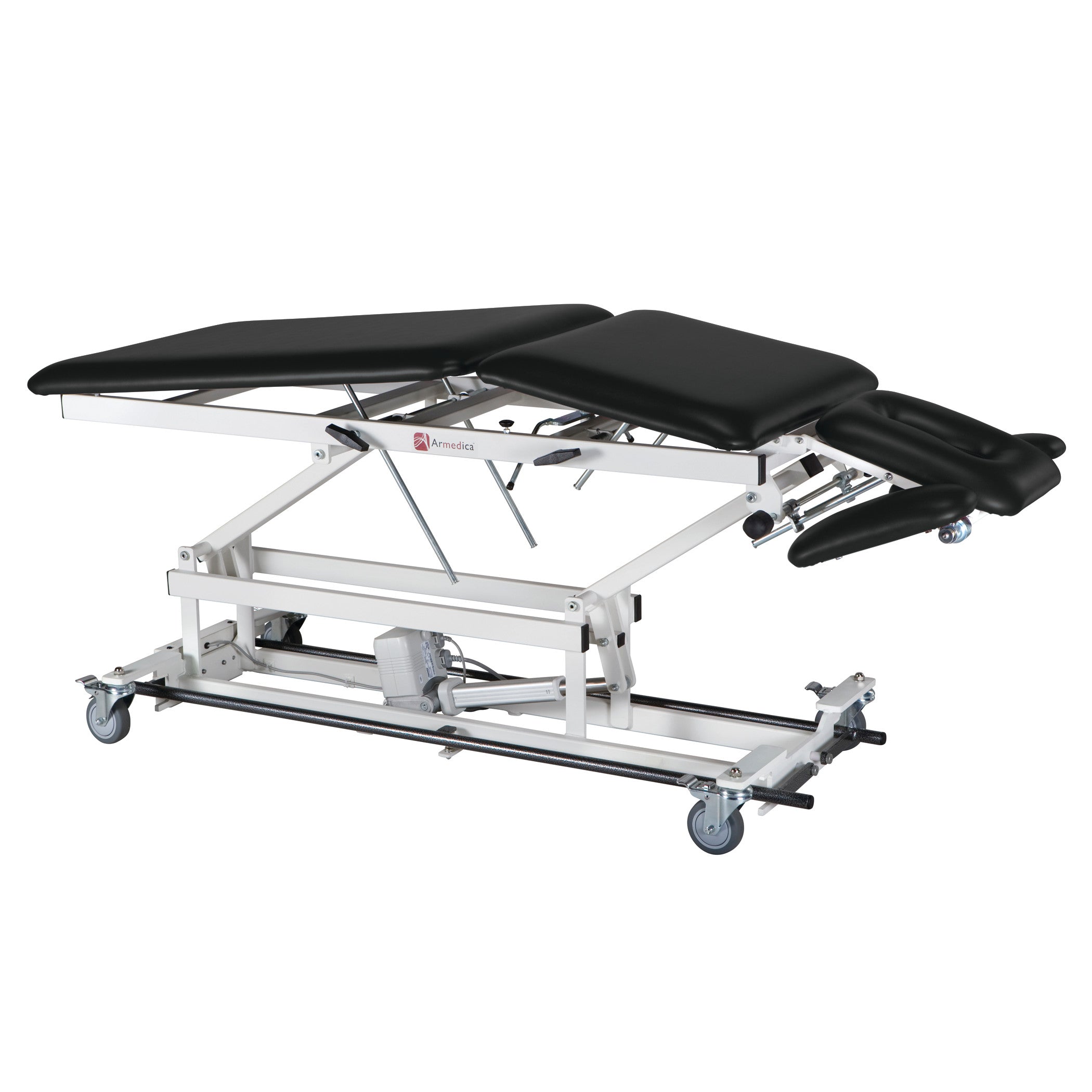The Armedica AM-BA500 Treatment Table has a black cushioned surface, adjustable sections, and white metal frame with mounted wheels.