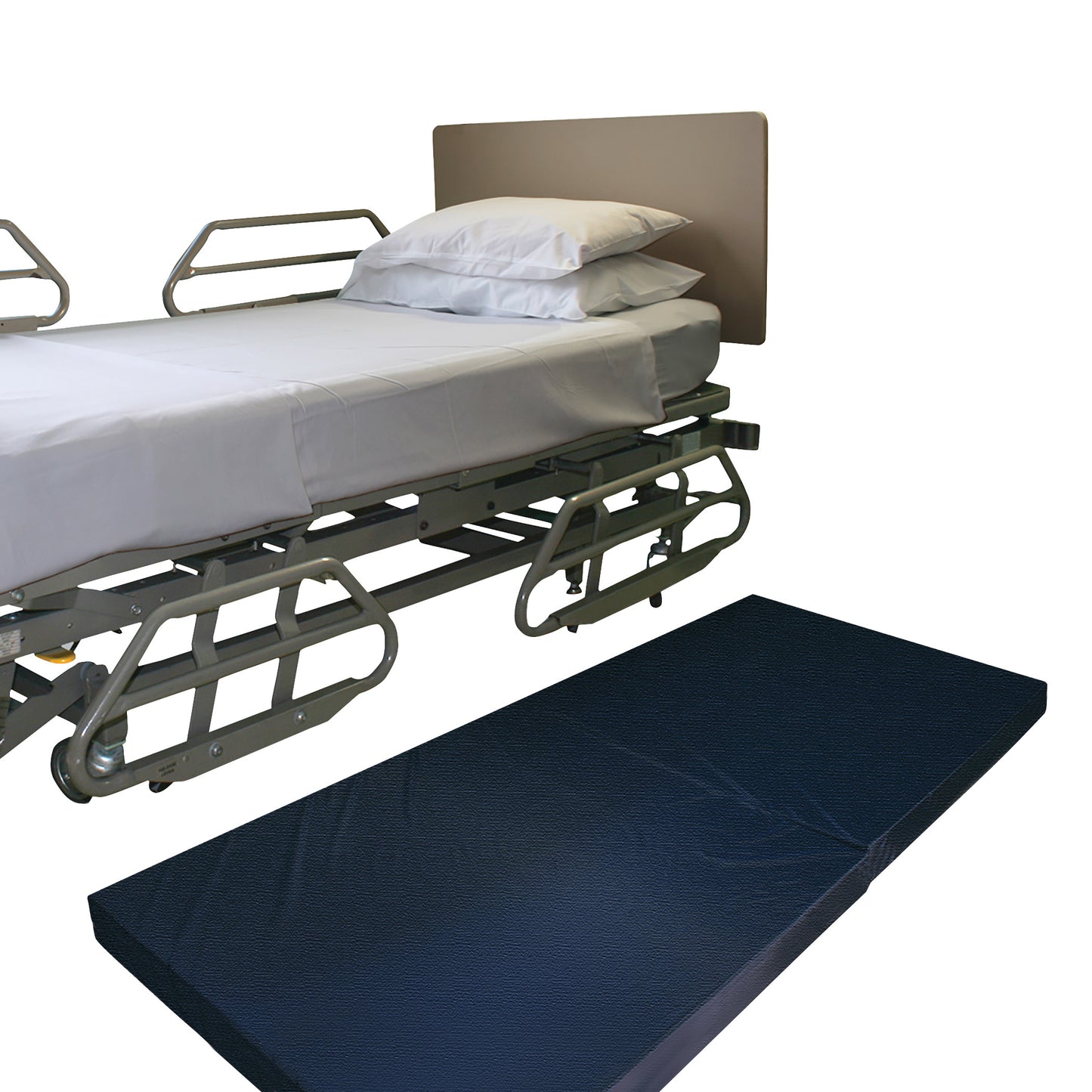 A hospital bed with side rails is shown alongside a NYOrtho Bedside Safety Mat placed on the floor next to it.