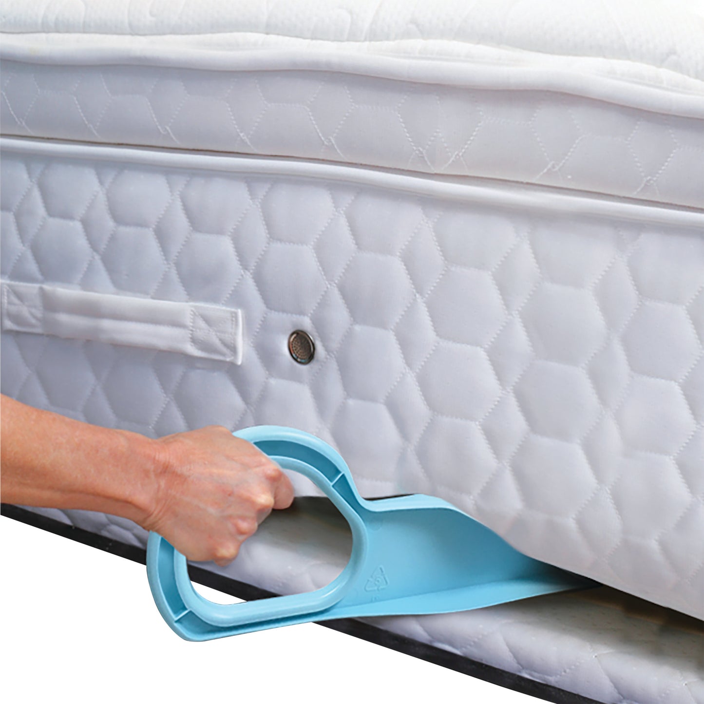 A hand uses the Bed MadeEZ Mattress Lifter, a blue tool, to lift a white mattress for easier bedding changes.