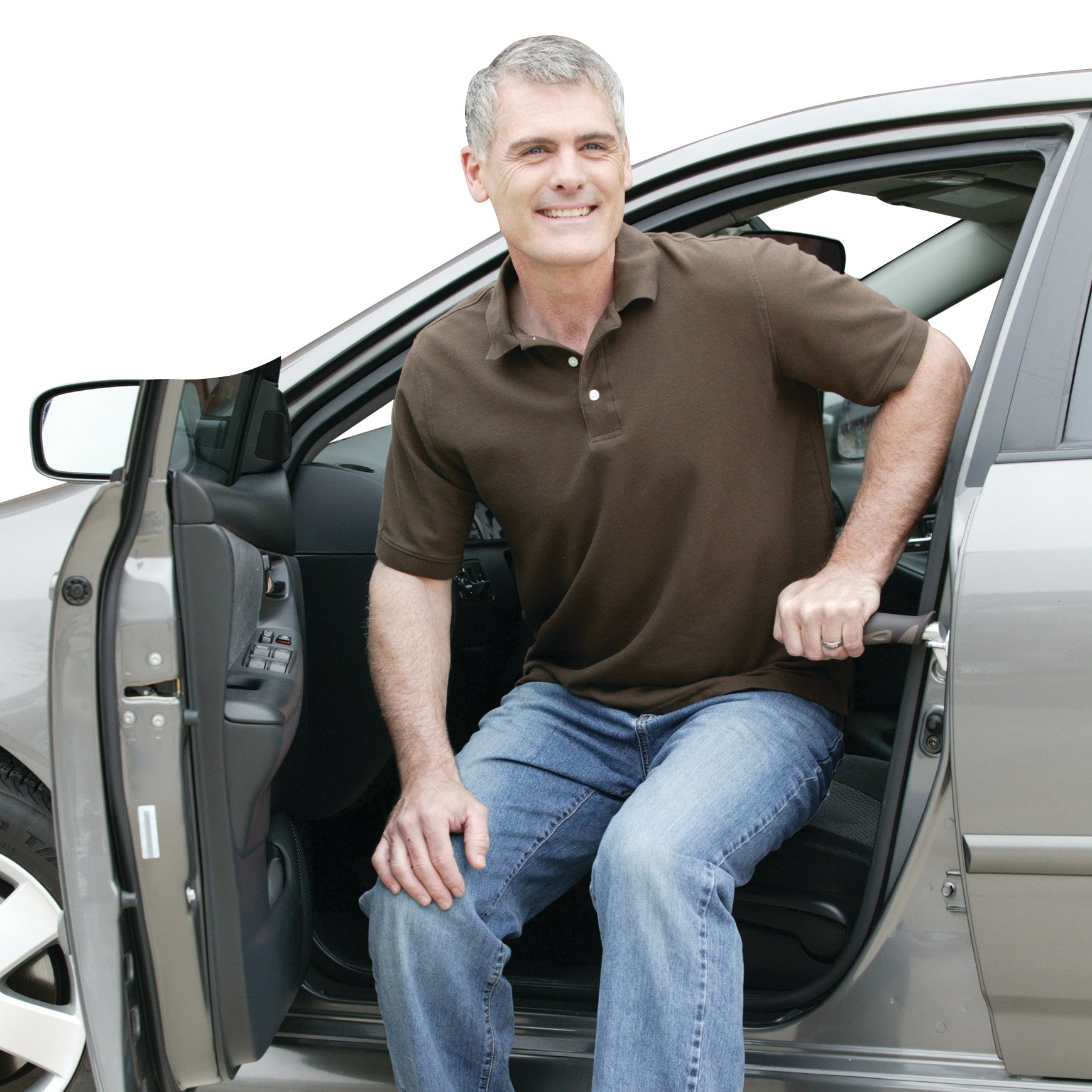 A man uses the Metro Car Handle Plus for support while exiting a car. The handle is inserted into the car door latch.