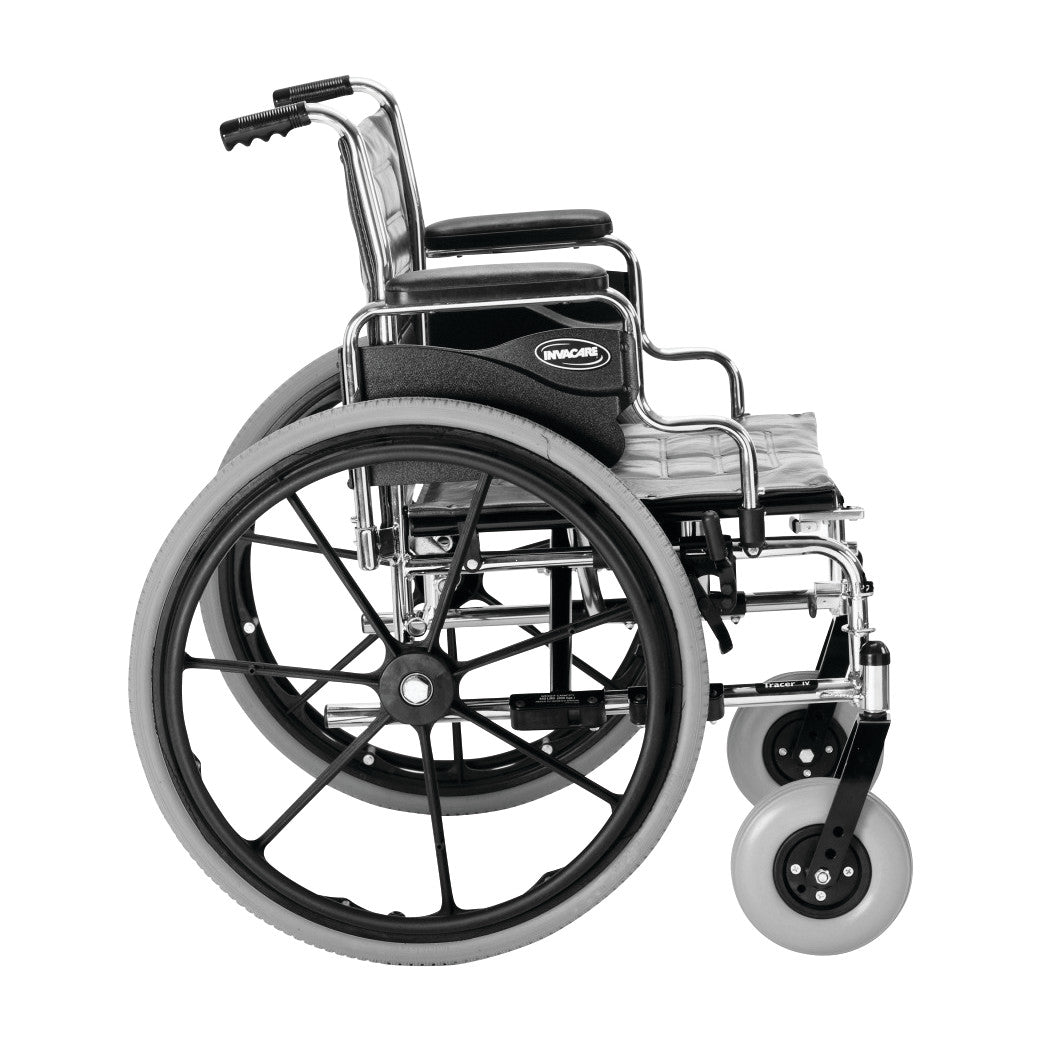Side view of an Invacare Tracer IV Wheelchair with Desk Arms and Flat-Free Tires, featuring a chrome frame and large rear wheels.