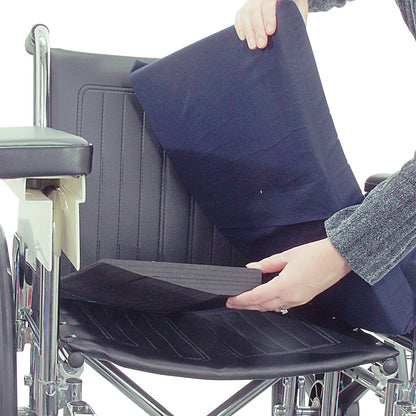 A person places an AliMed Wheelchair Half Seat Wedge on a wheelchair seat, enhancing comfort and positioning.