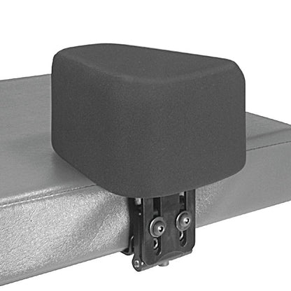 Therafin Flip-Down Abductor attached to a padded bench or medical table, featuring a cushioned block and adjustable bracket.