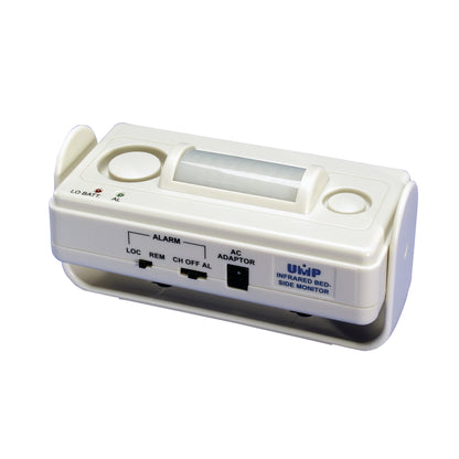 UMP Infrared Bedside Alarm, a small white device with switches for alarm settings and AC adapter, designed for patient monitoring.
