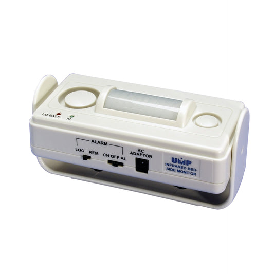 UMP Infrared Bedside Alarm, a small white device with switches for alarm settings and AC adapter, designed for patient monitoring.