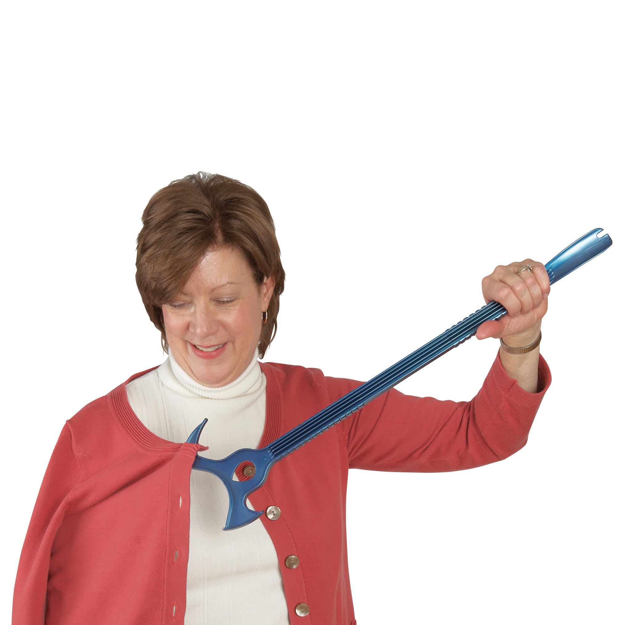 A woman uses a Combination Dressing Stick, a blue tool with a hook, to assist in dressing by pulling on a red cardigan.