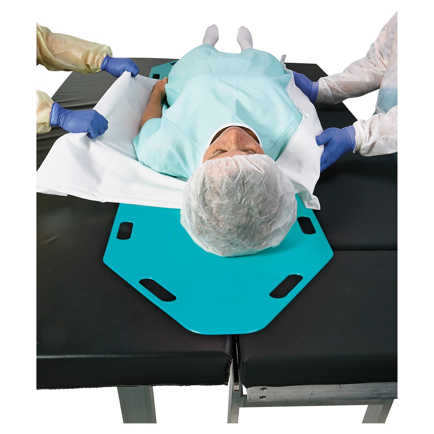 A patient on the AliMed Anti-Stat Patient Shifter is being moved by two people wearing protective clothing and gloves.