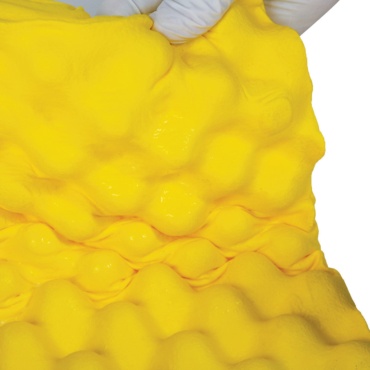 The AliMed Protecta-Coat Egg Crate Waterproof Ulnar Pad is held by gloved hands, displaying its bright yellow, textured surface.