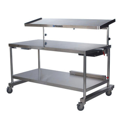 The Pedigo Space Station is a stainless steel mobile medical procedure table with a raised shelf and rolling casters for easy movement.