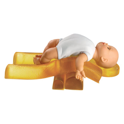 A baby doll in a white outfit is positioned on the AliMed AliGel Pediatric Positioning Set, which is yellow and textured.