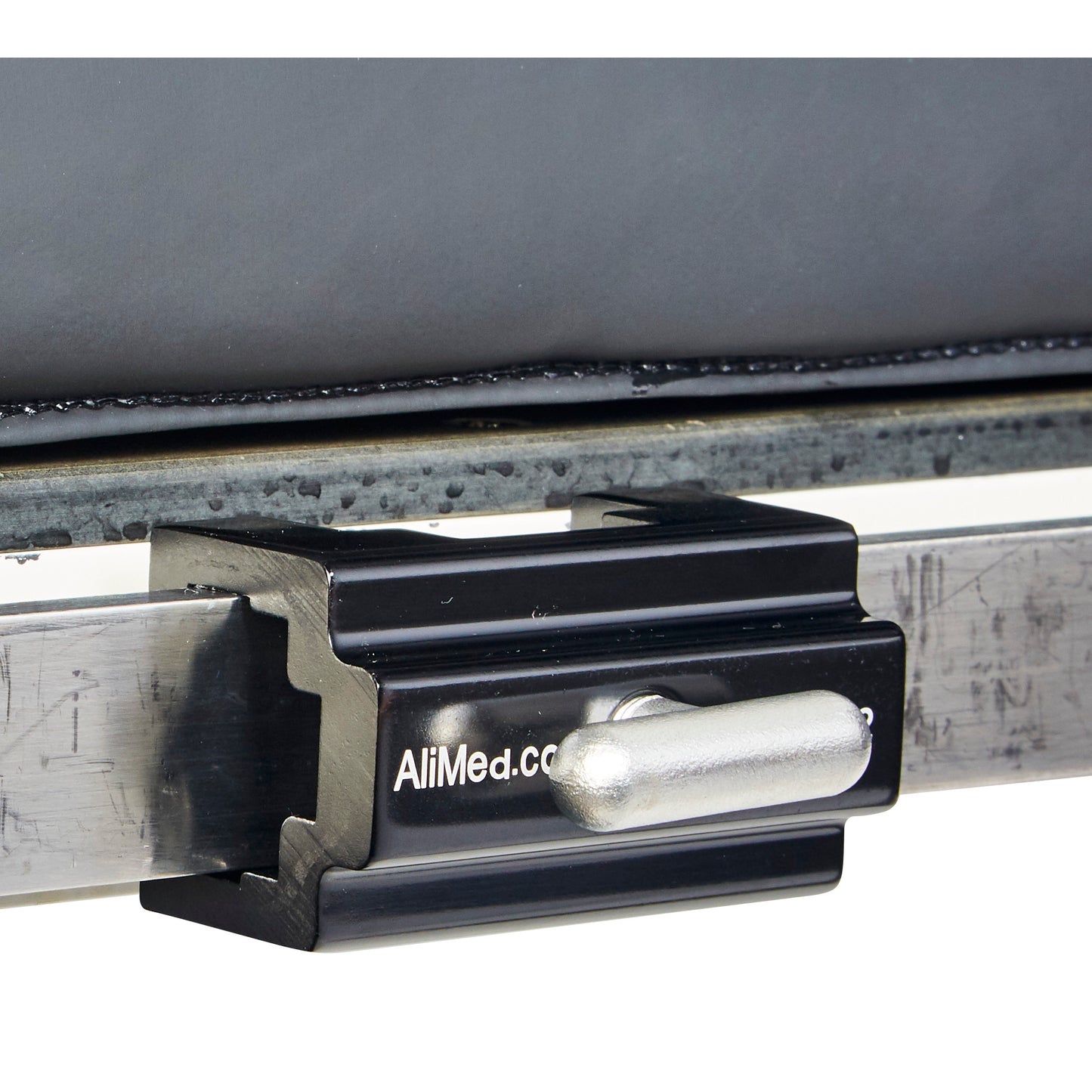 The AliMed Anodized Aluminum Side Rail Socket is shown securing a metal rail, featuring a black finish with a visible locking pin.