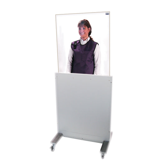 A person stands behind a movable, transparent RayShield Adjust-A-Height Barrier on wheels, wearing a protective vest.