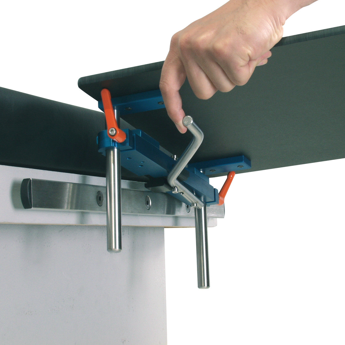A hand adjusts the AliMed Quick-Snap Table Clamp, made of blue and metal components, securing it to a table edge.