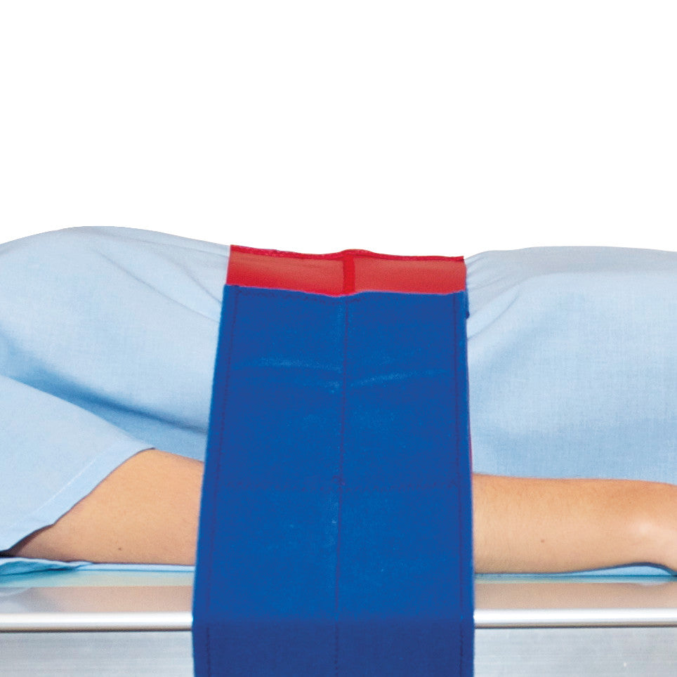 A person lies under an AliMed Universal Strap, One-Piece, One Closure, No Side Rail, which is blue with a red top section.