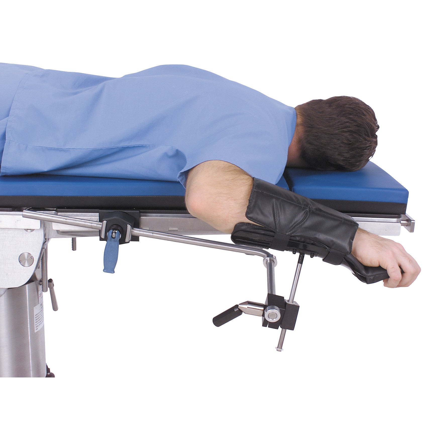 A person lies face down on a table, with their arm secured using a Replacement Pad for Allen Lateral and Prone Arm Support.