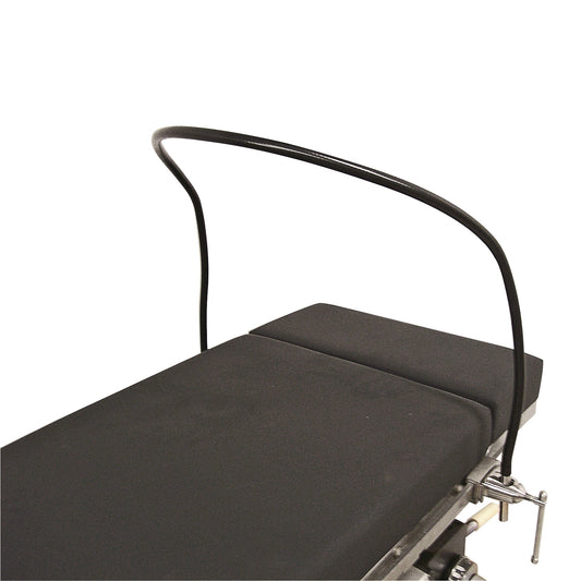 Malleable Anesthesia Screen attached to the side of a padded medical table, with a curved metal frame overhanging the cushion.