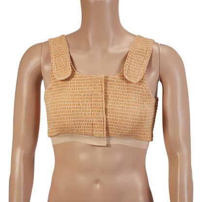 A mannequin wears an Expand-A-Band Compression Bra in beige, featuring wide straps and a textured front closure.