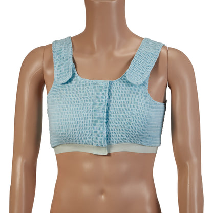 The Expand-A-Band Compression Bra is shown on a mannequin. It is light blue with wide shoulder straps and a front closure.