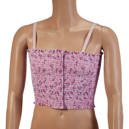 A mannequin wears an Expand-A-Band Lined Breast Binder, a pink, smocked crop top with thin straps and a floral pattern.