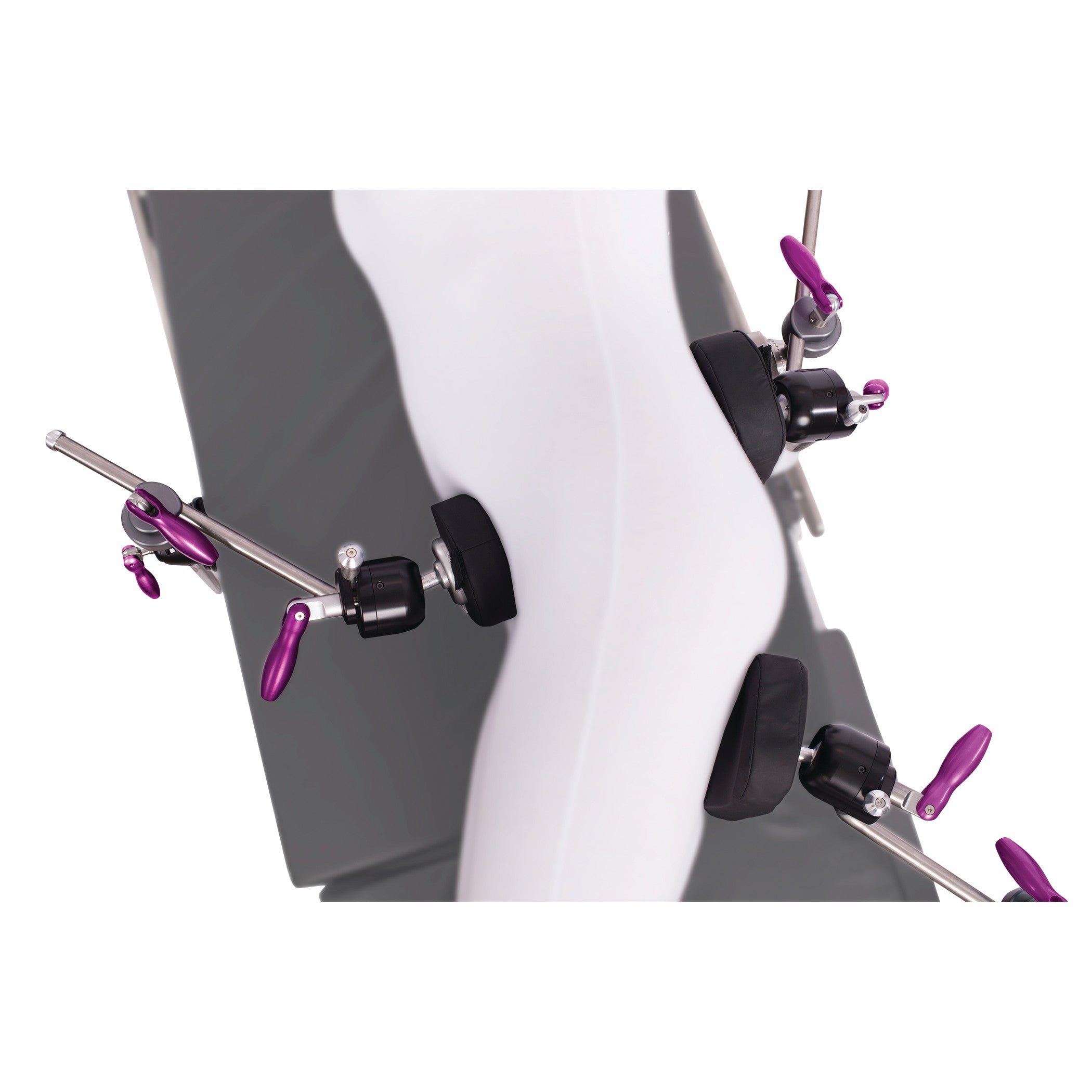The KYRA Lateral Positioning Set secures a mannequin leg with multiple padded clamps and purple levers for medical positioning.