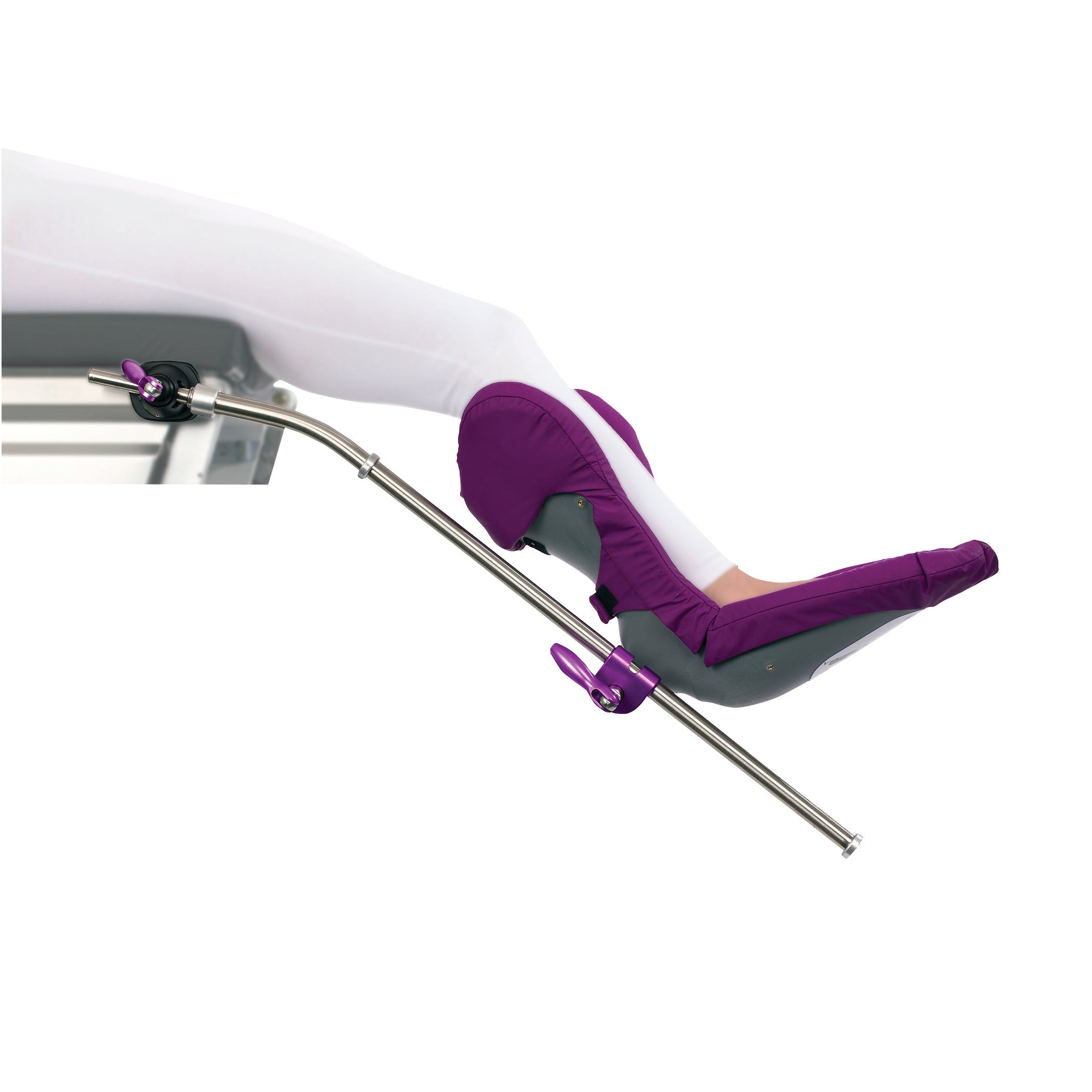 A patient's leg secured in the KYRA Well Leg Holder, featuring a purple padded support and adjustable metal arm.
